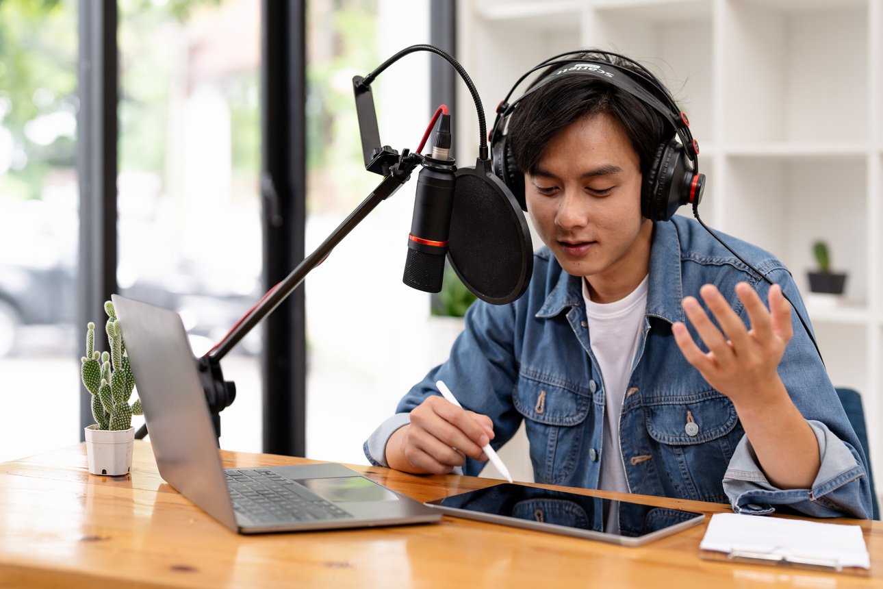 Man and woman podcasters interview each other for radio podcast